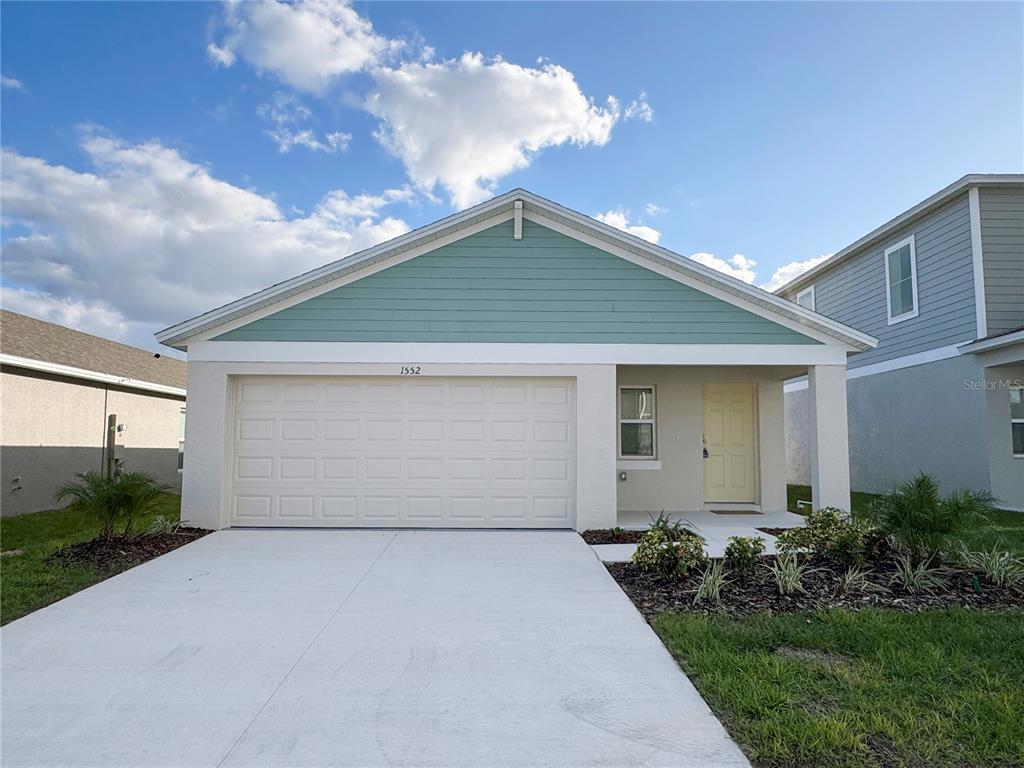 a front view of house with garage and yard