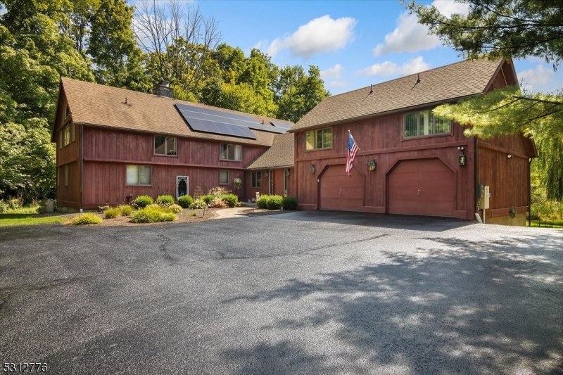 a view of a house with a yard and garage