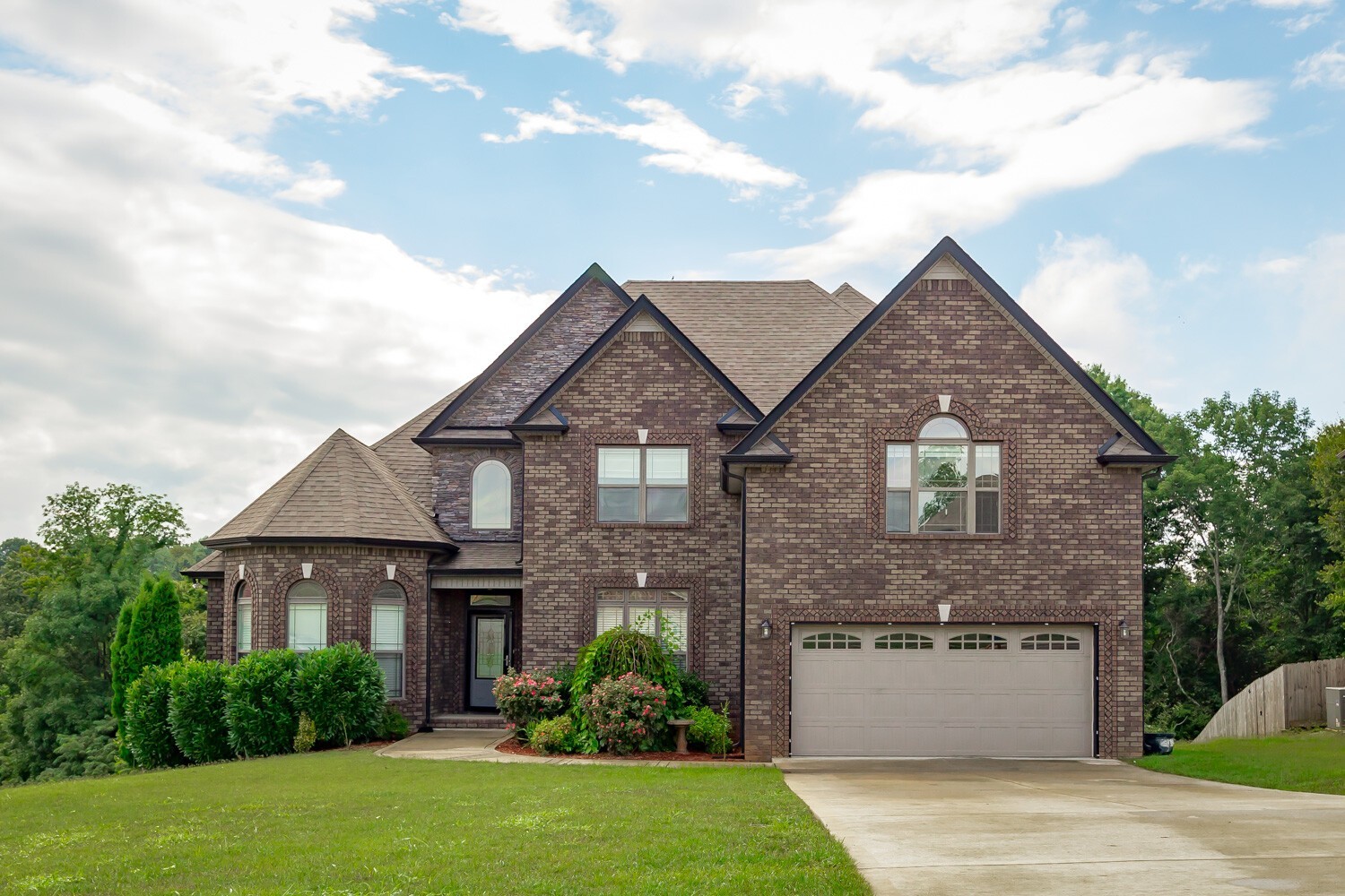 a front view of a house with a yard and garage