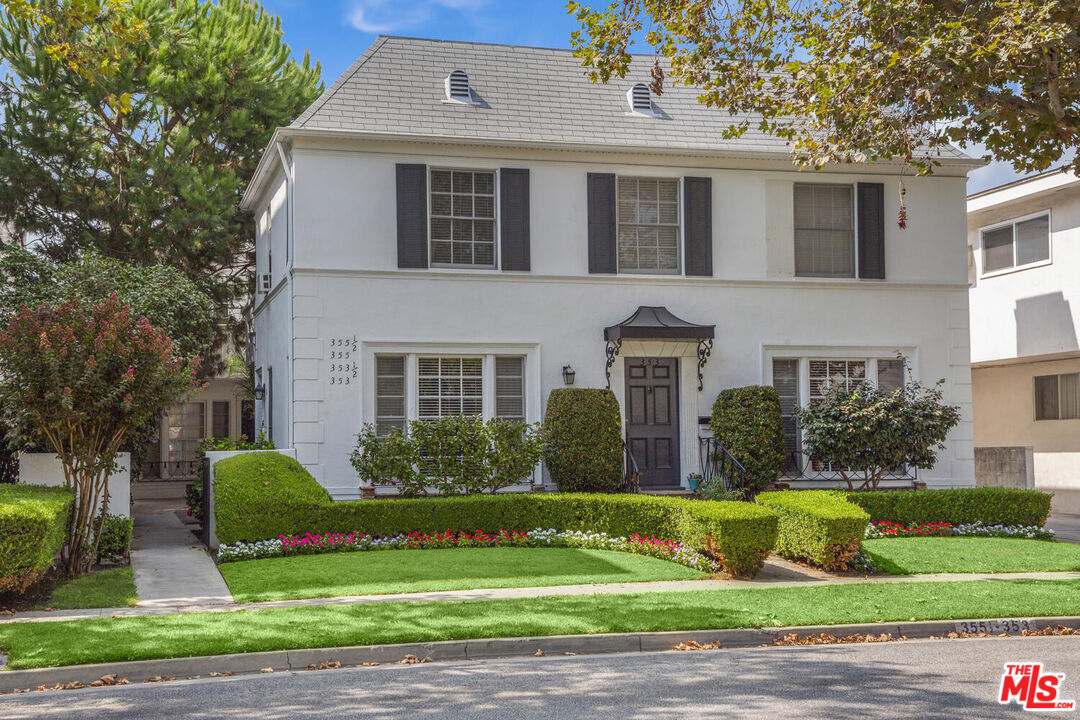 a front view of a house with garden