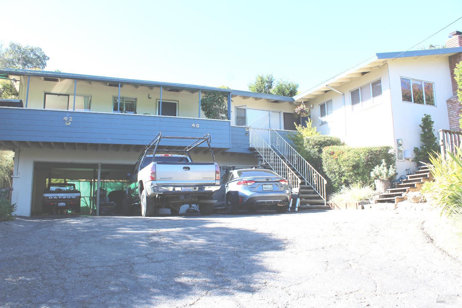 a view of a car park front of a house