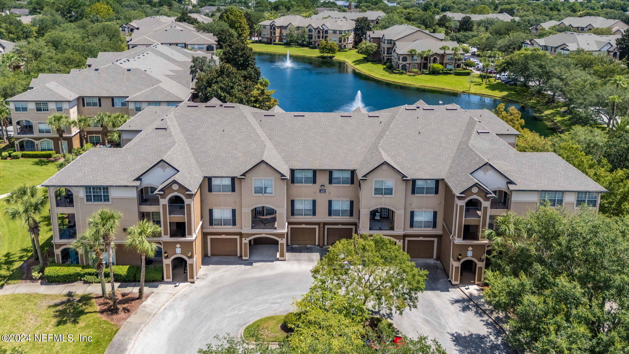 an aerial view of residential houses with yard and swimming pool