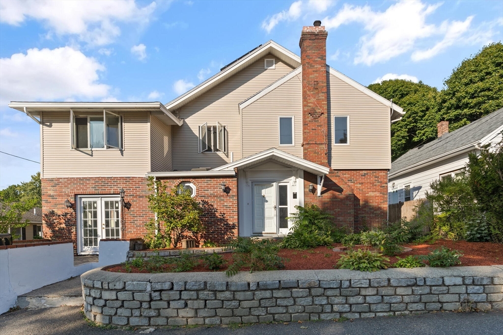 a front view of a house with garden