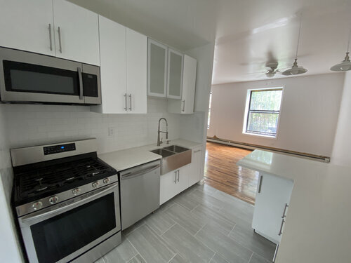 a kitchen with stainless steel appliances and white cabinets