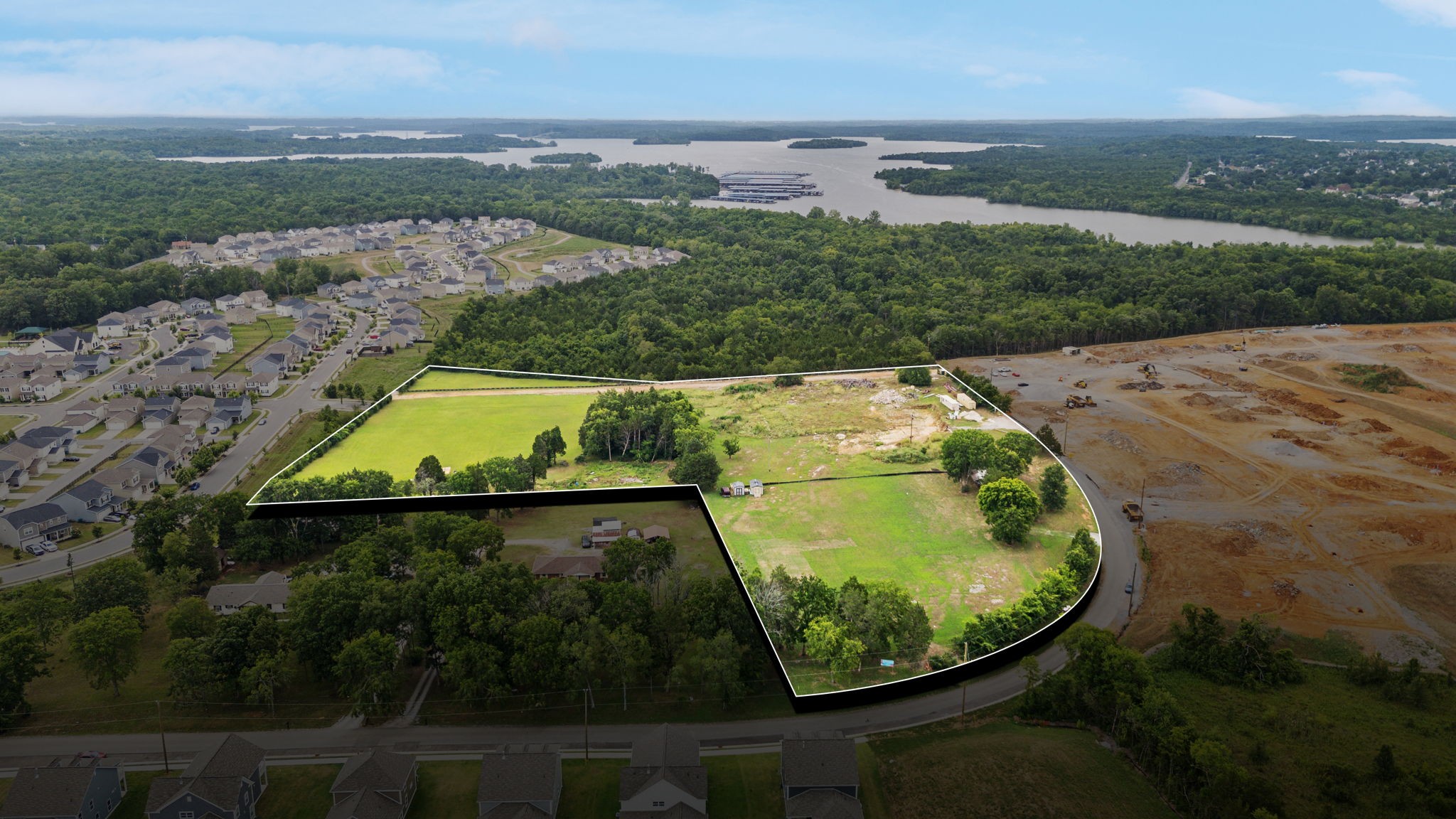 an aerial view of a swimming pool with a yard