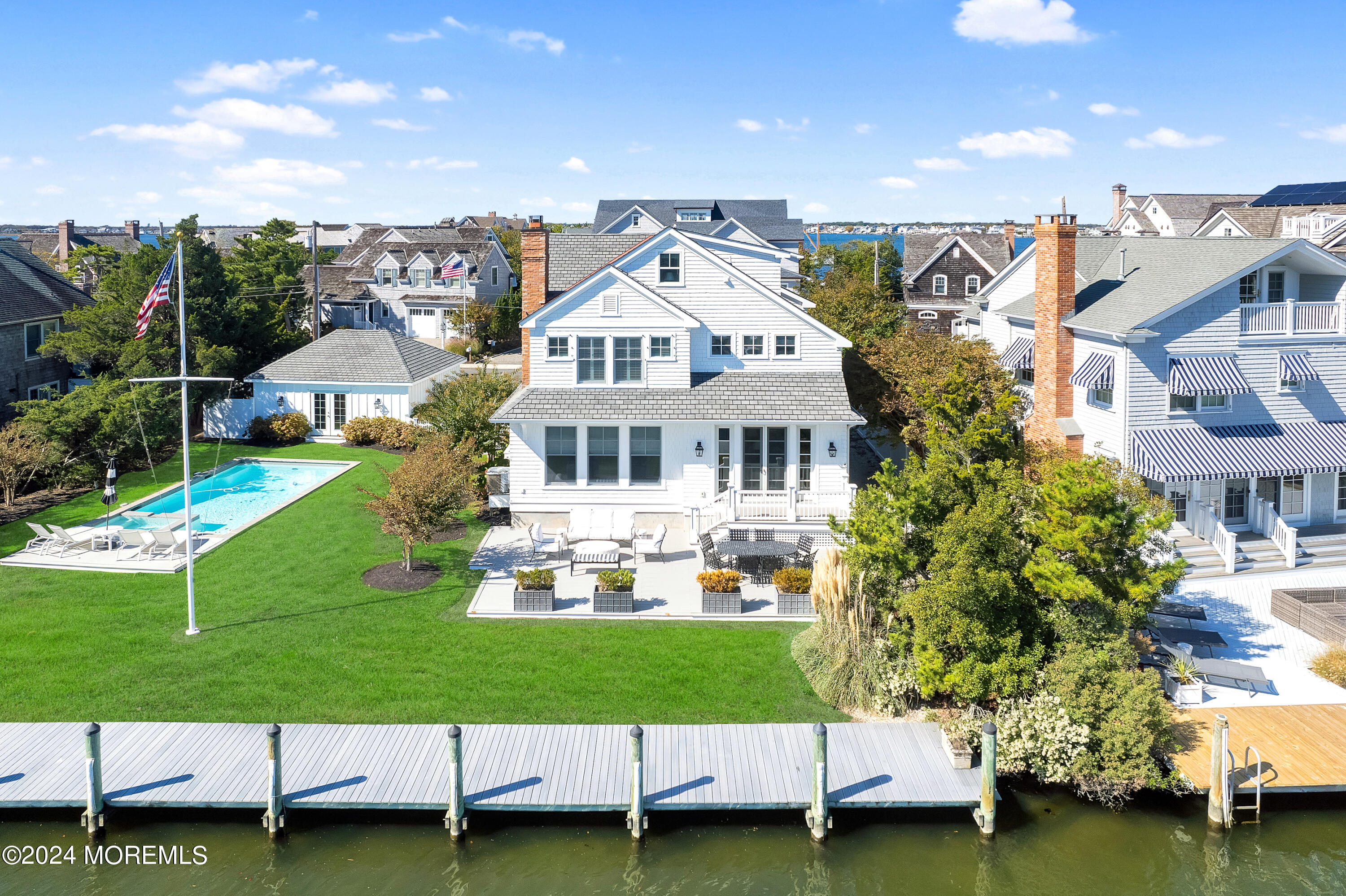 a aerial view of a house with a garden and lake view