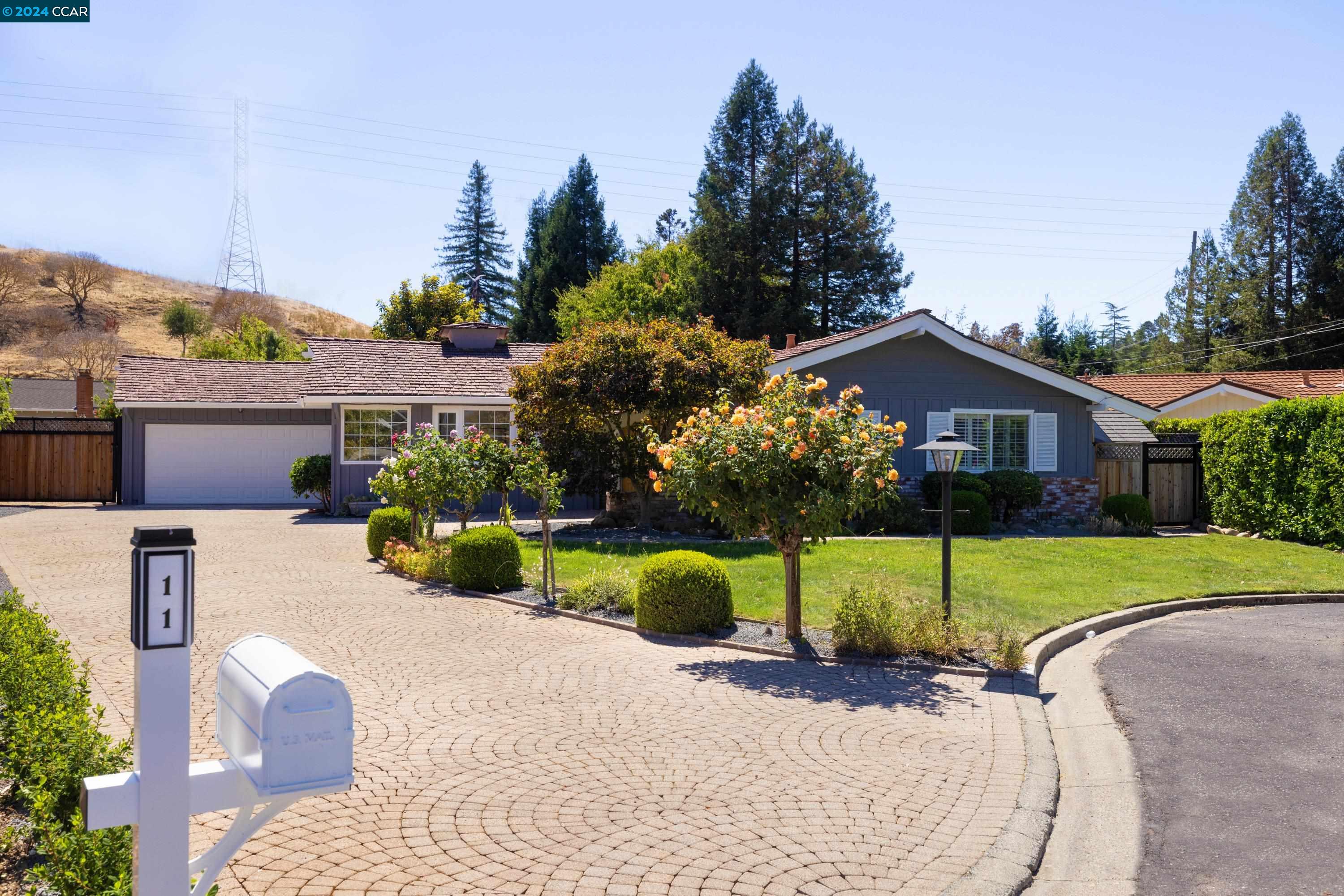 a view of a house with backyard and sitting area