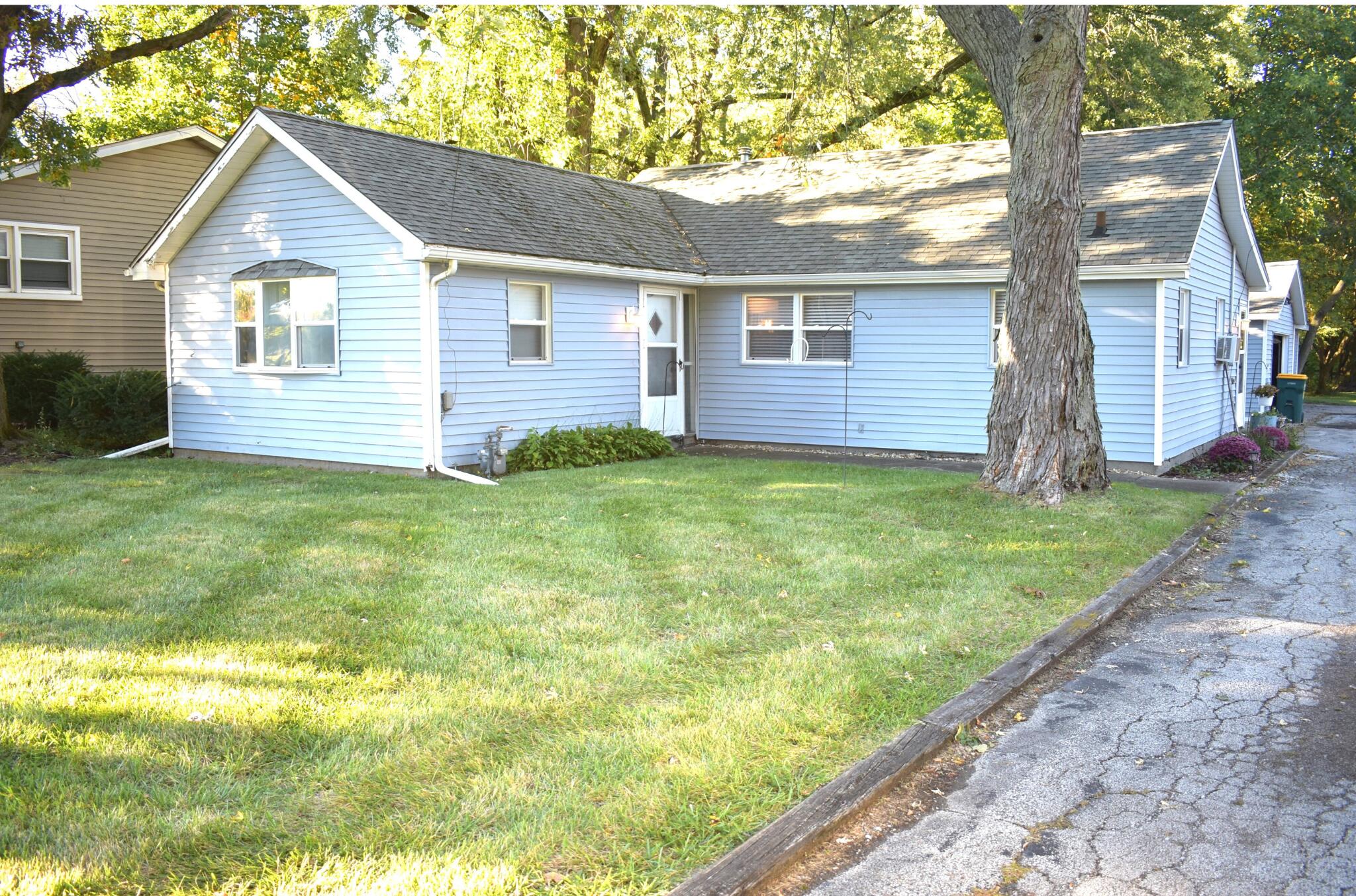 a view of a house with yard and tree s