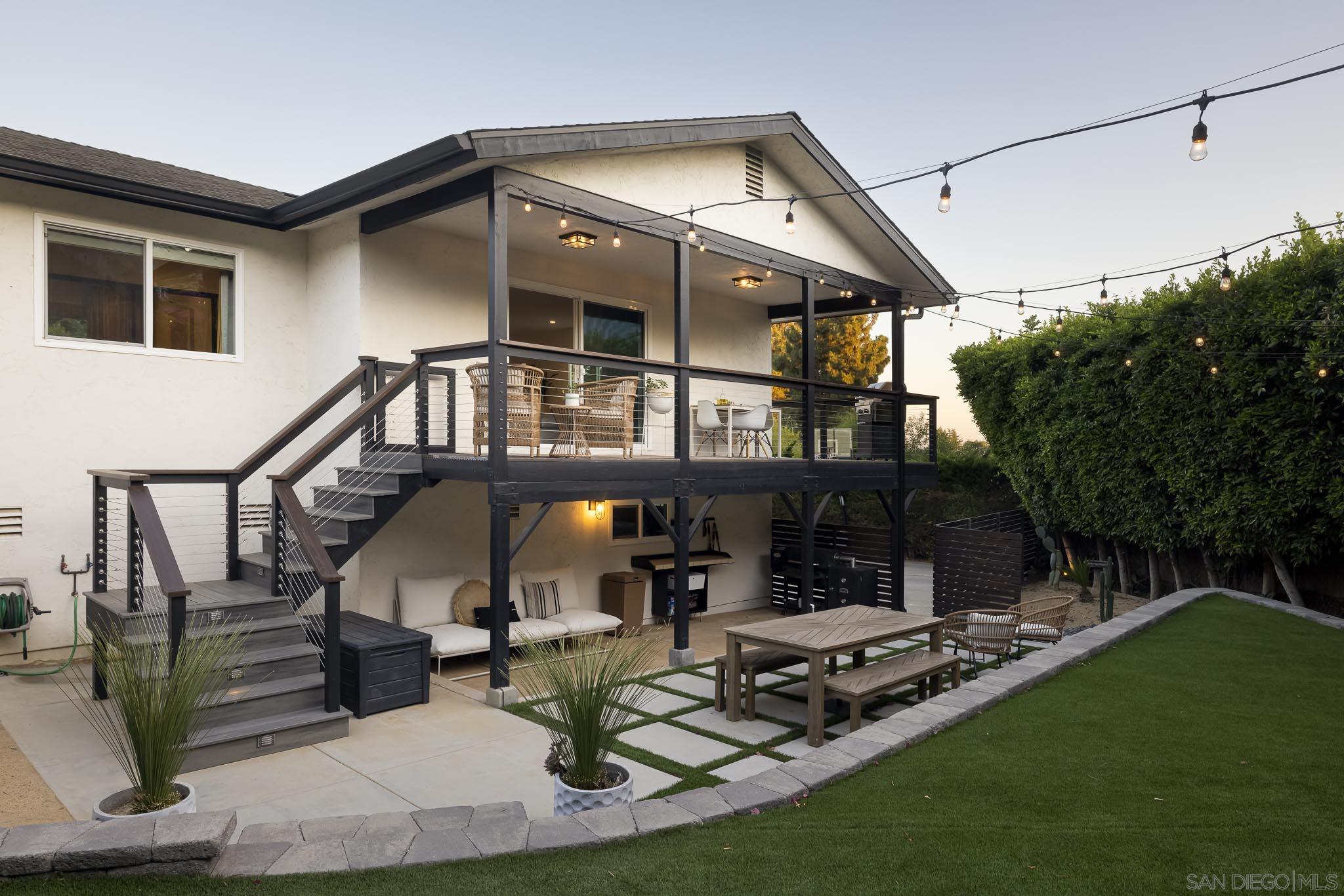 a view of a house with patio and a yard