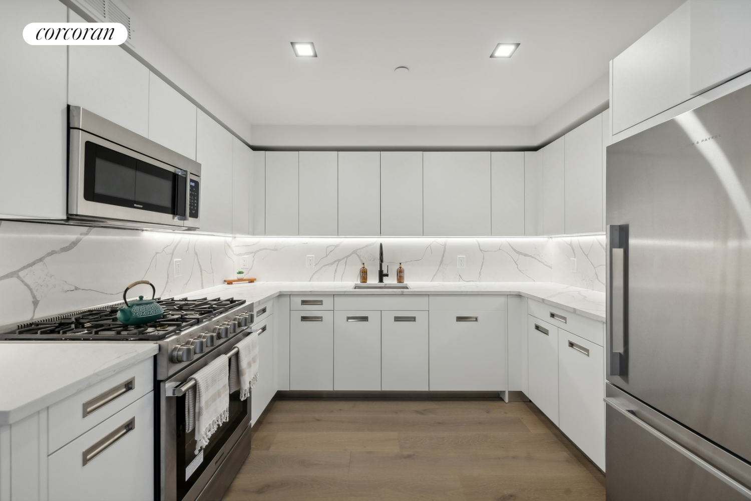 a kitchen that has a sink and a stove