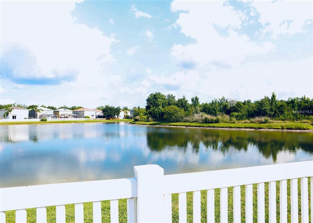 a view of a lake with houses in the back