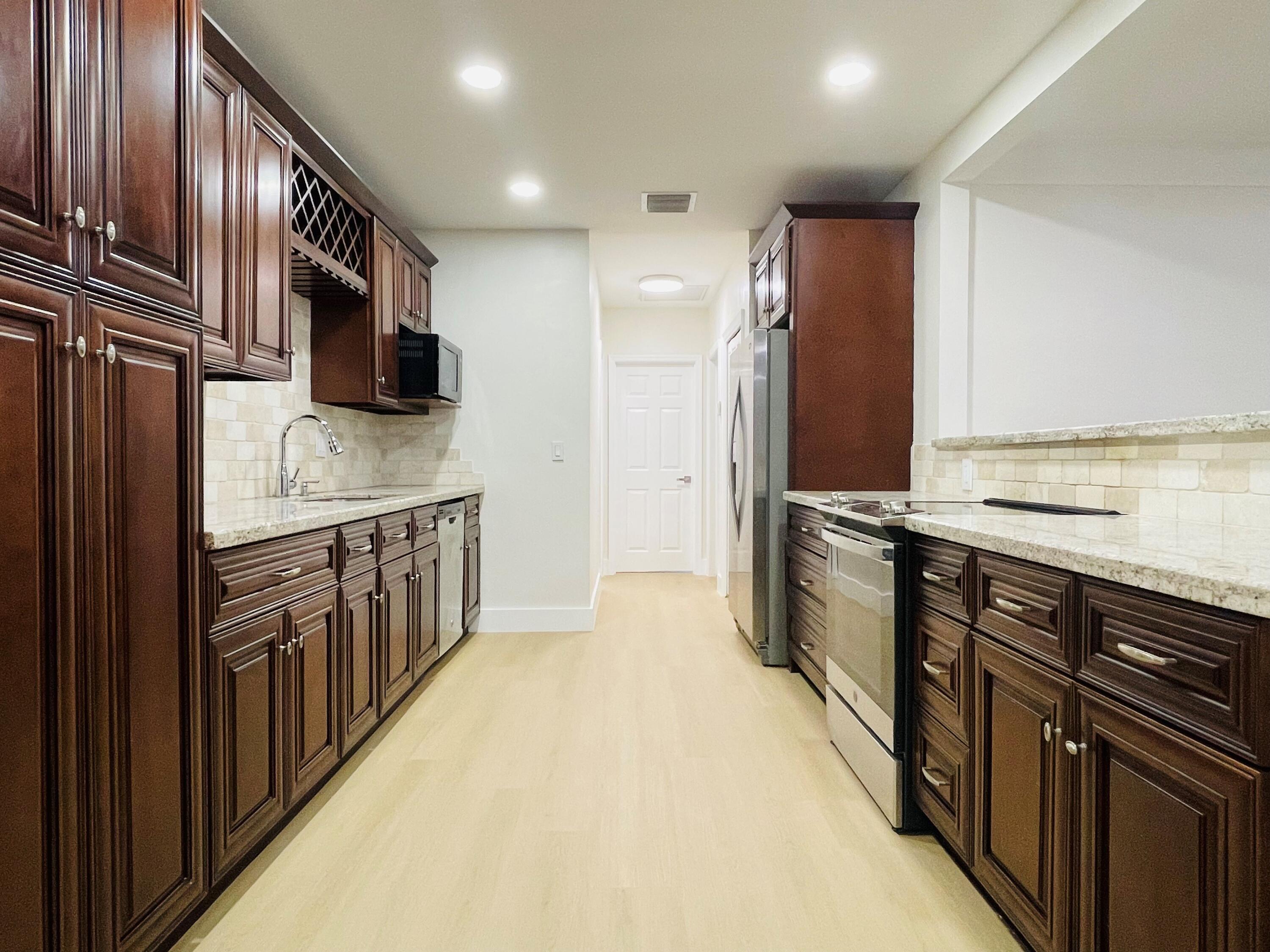 a kitchen with stainless steel appliances a sink and a stove top oven