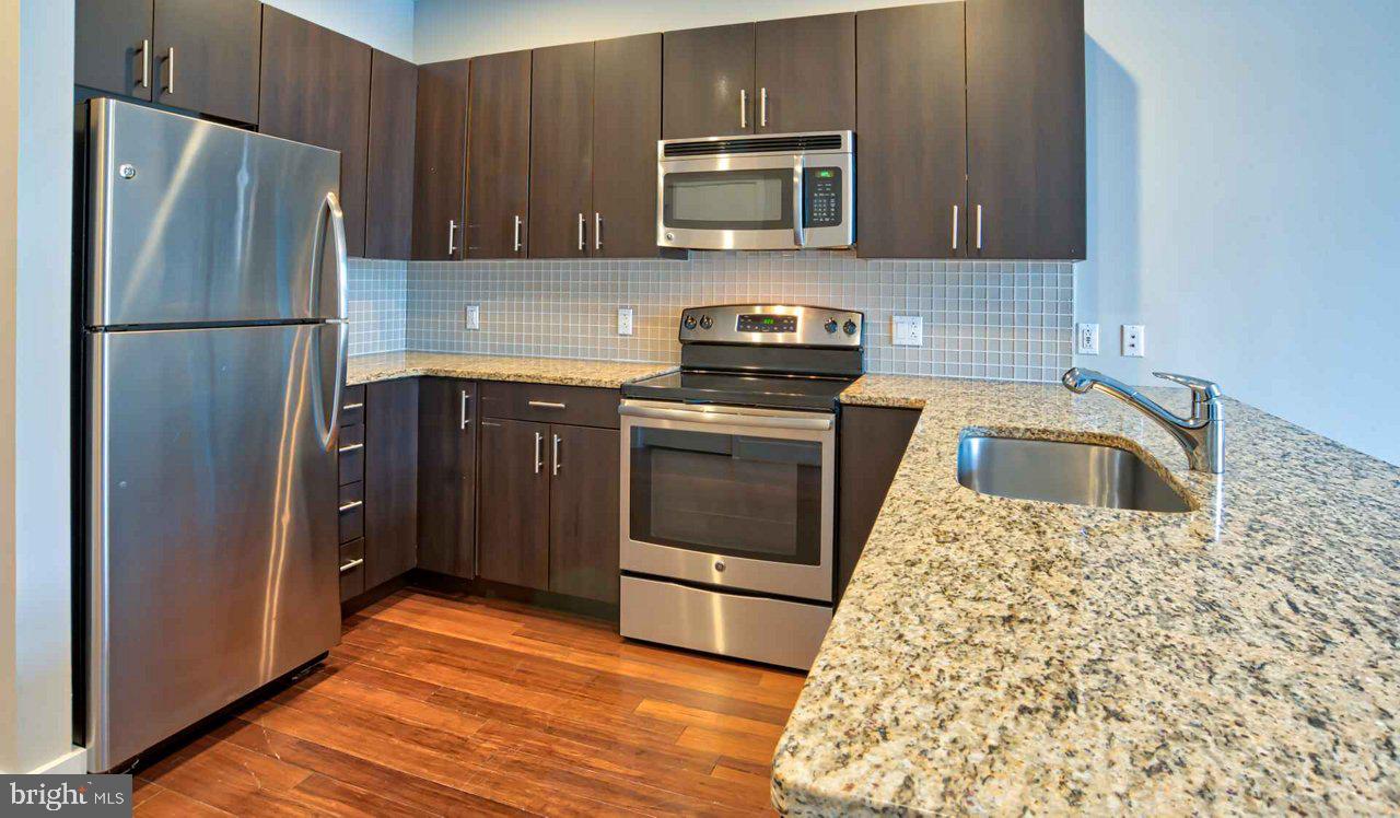 a kitchen with a sink stove and refrigerator