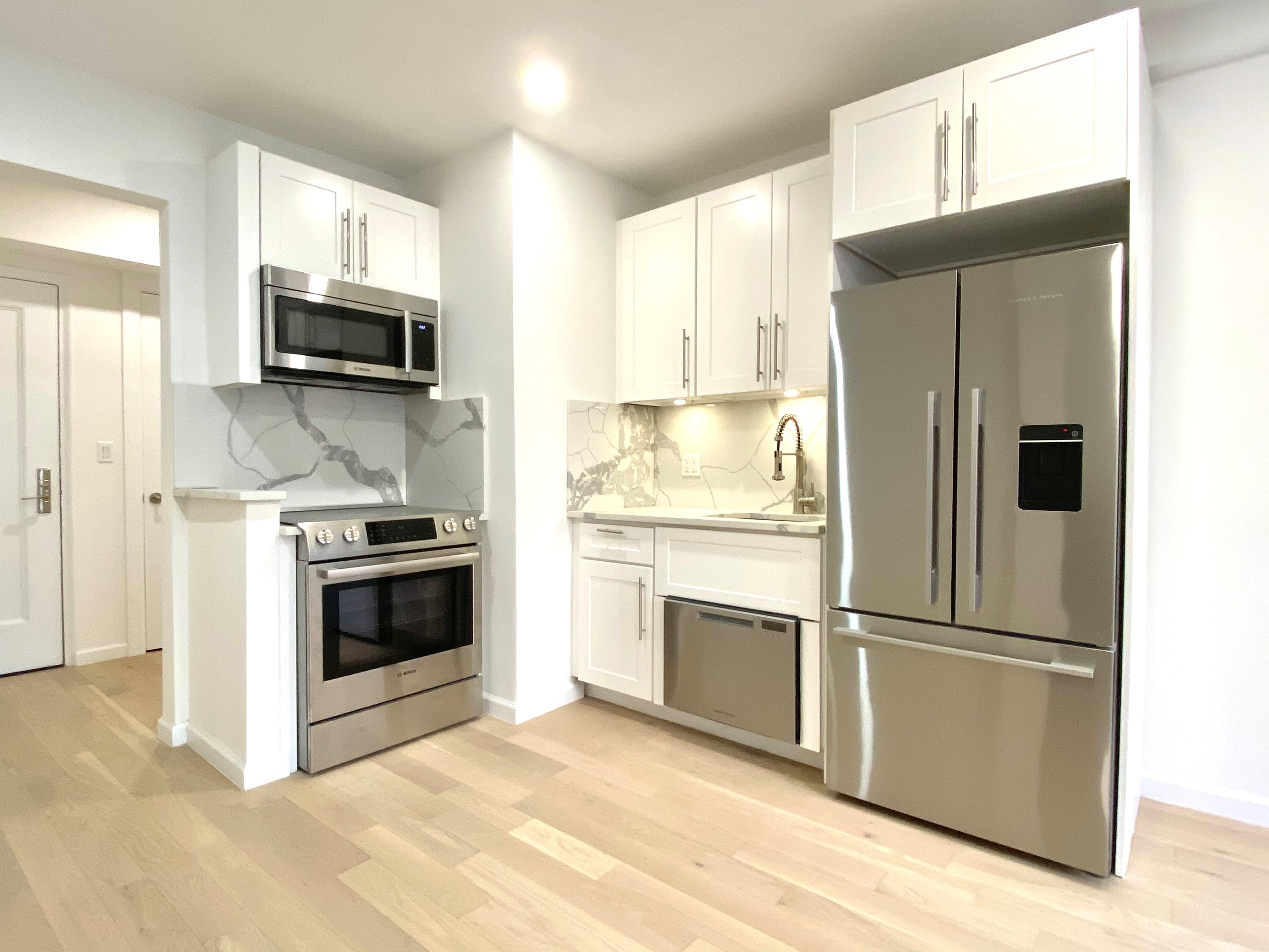 a kitchen with stainless steel appliances a refrigerator stove and microwave