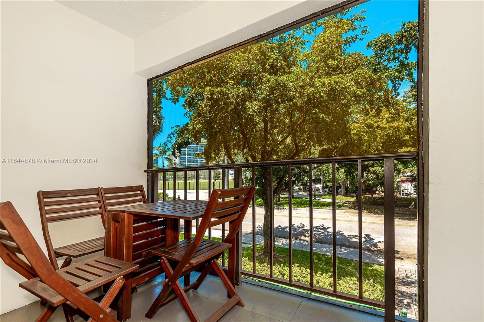 a view of a chairs and table in a balcony