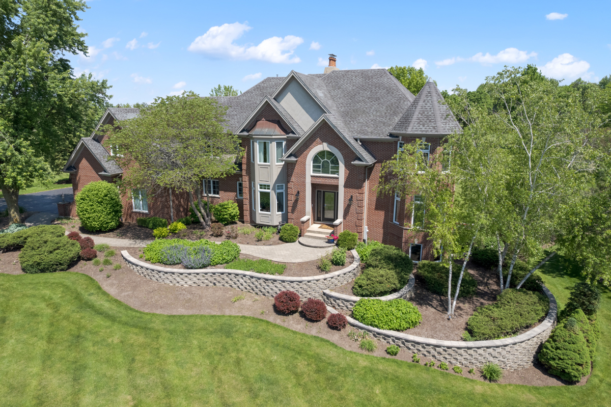 a aerial view of a house with swimming pool and garden