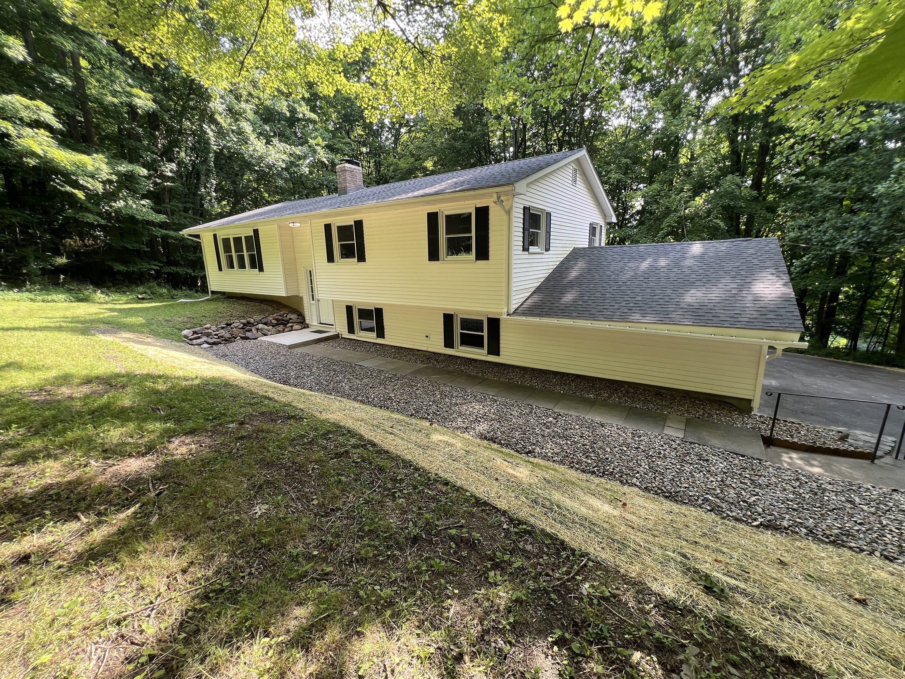 a view of a house with a yard and sitting area