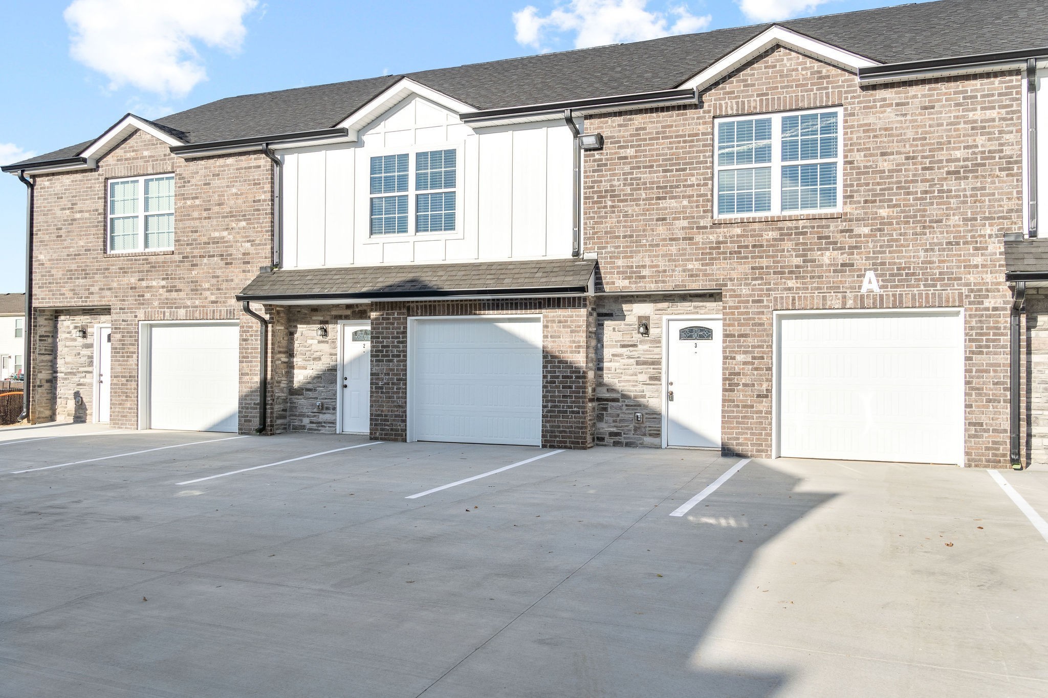 a view of a house with a garage and window