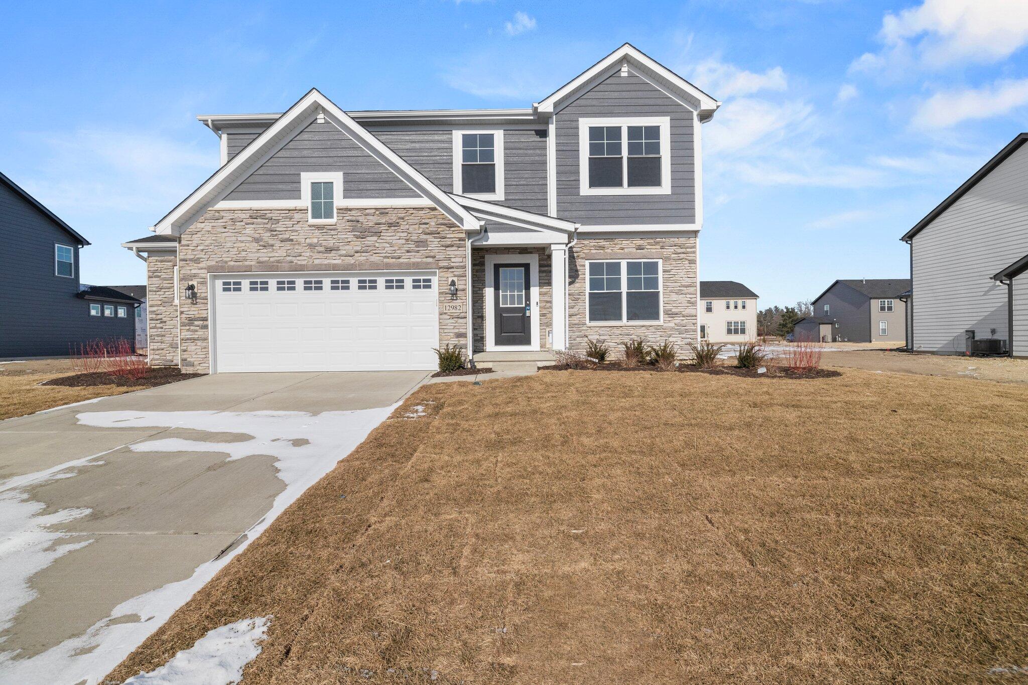 a front view of a house with a yard