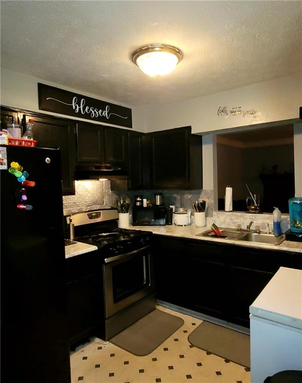 a kitchen with sink and cabinets