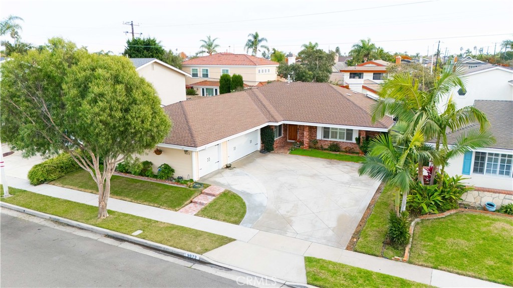 an aerial view of residential houses with outdoor space and trees