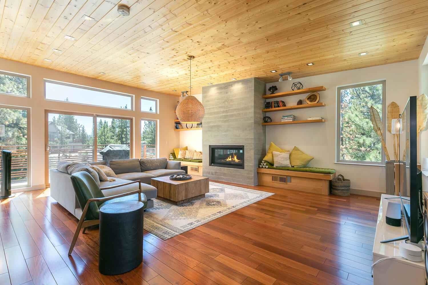 a living room with fireplace furniture and a large window