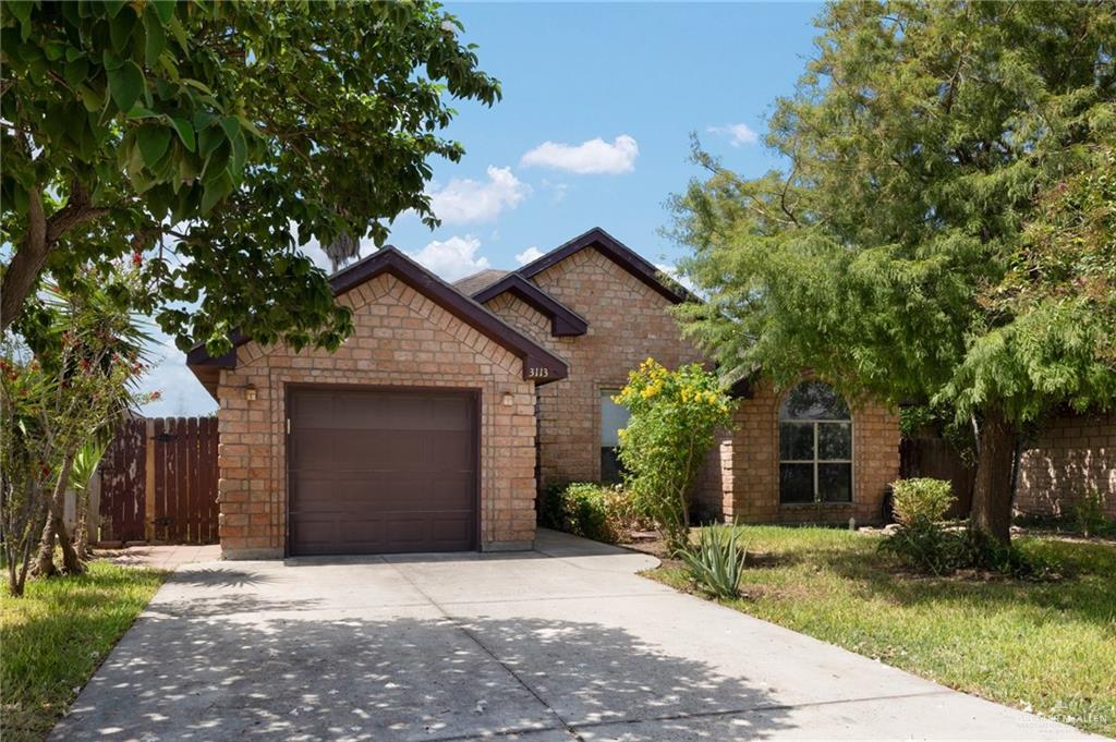 a front view of a house with a yard and a garage