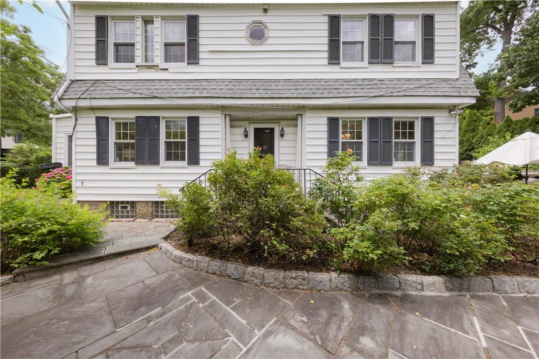 front view of house with potted plants