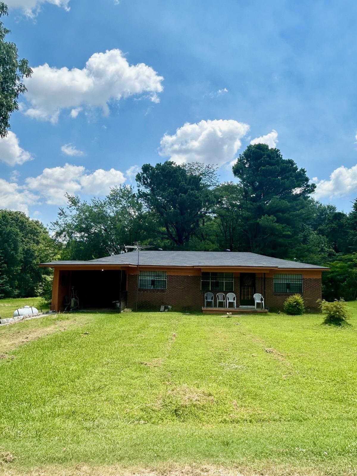 Single story home with a front lawn