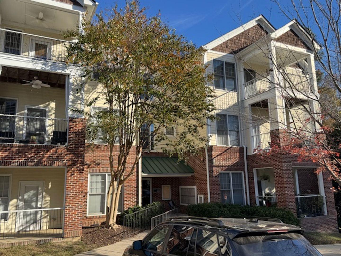 a front view of a residential apartment building with a yard