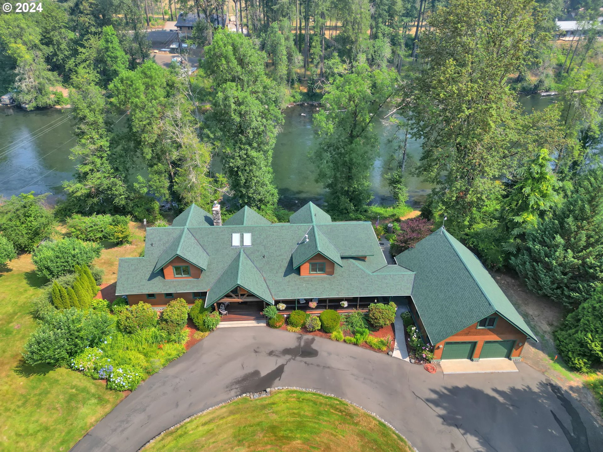 an aerial view of a house with swimming pool and outdoor space