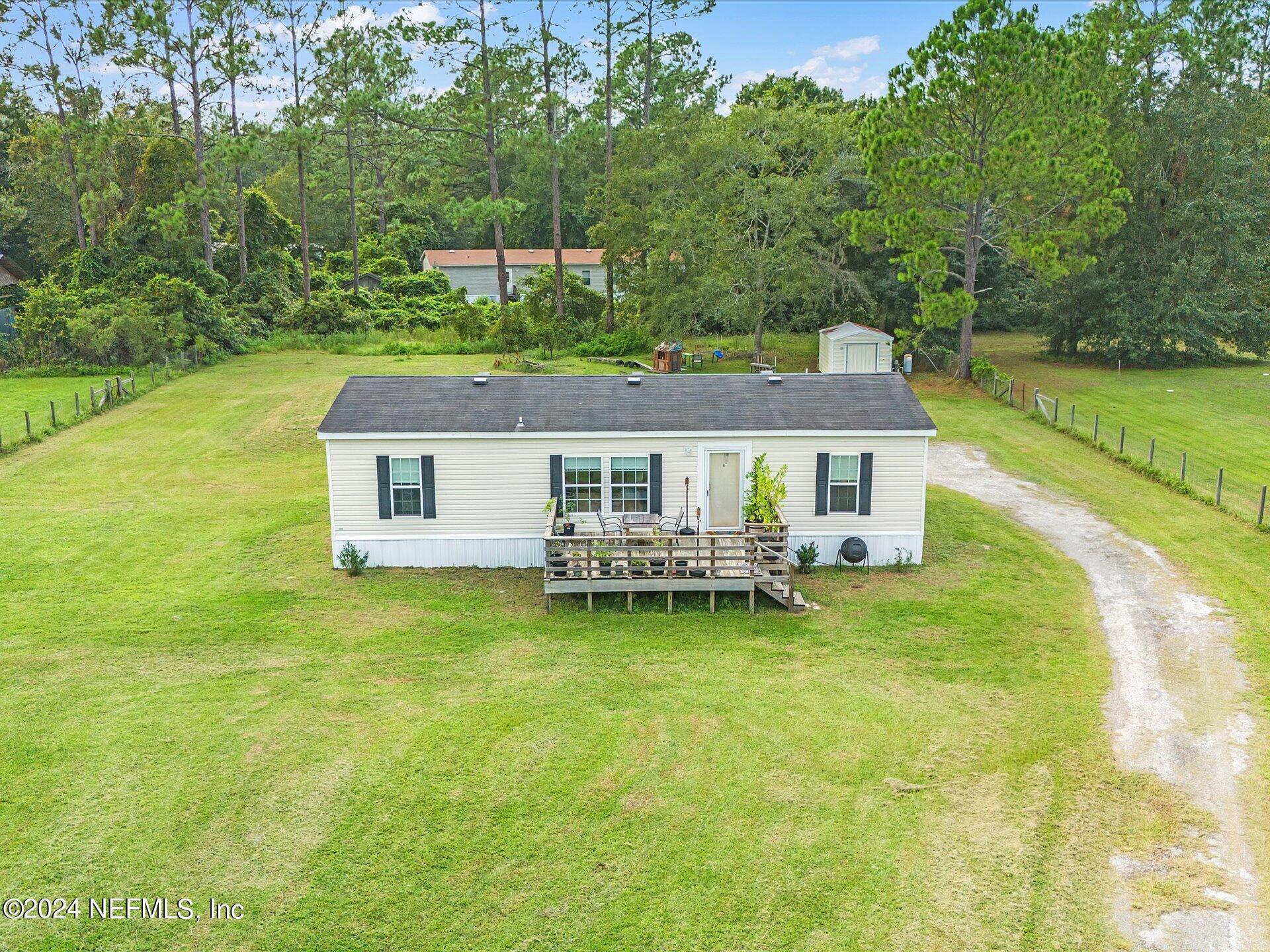 an aerial view of a house with swimming pool garden and patio