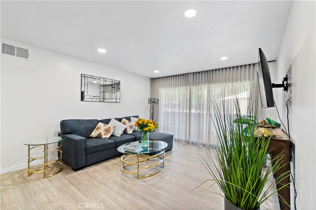 a living room with furniture flowerpot and a potted plant