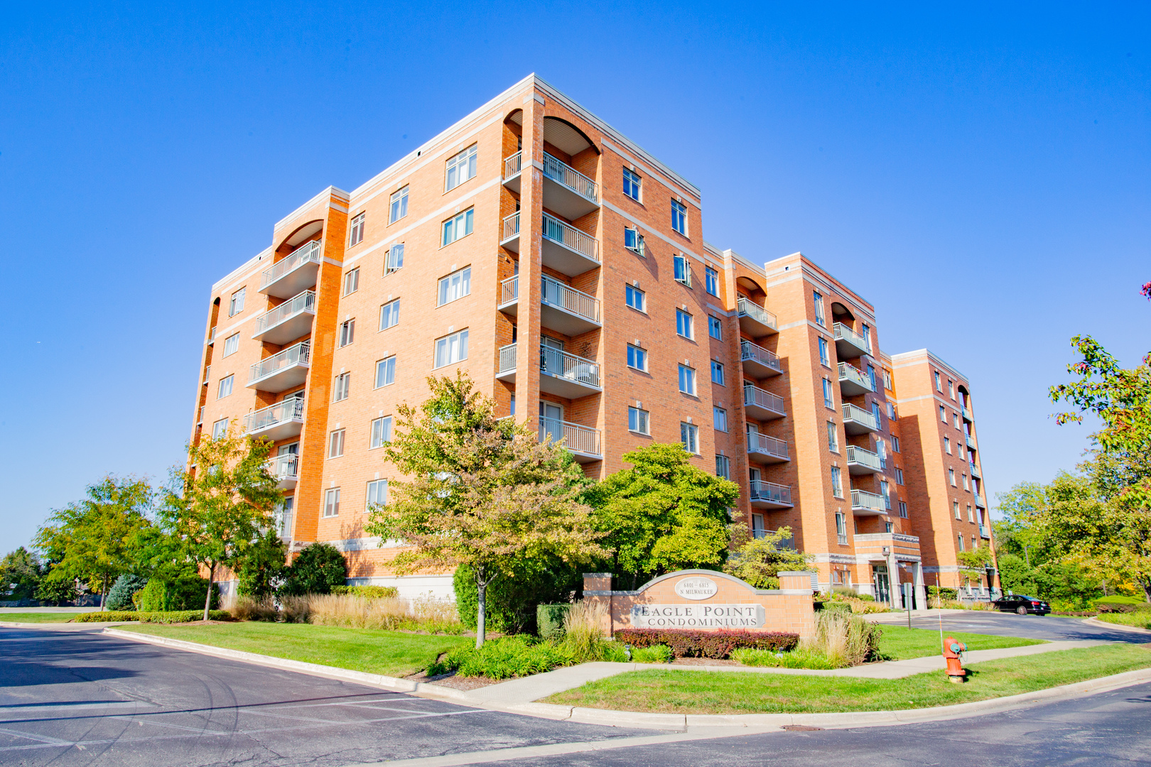 a view of a tall building next to a yard