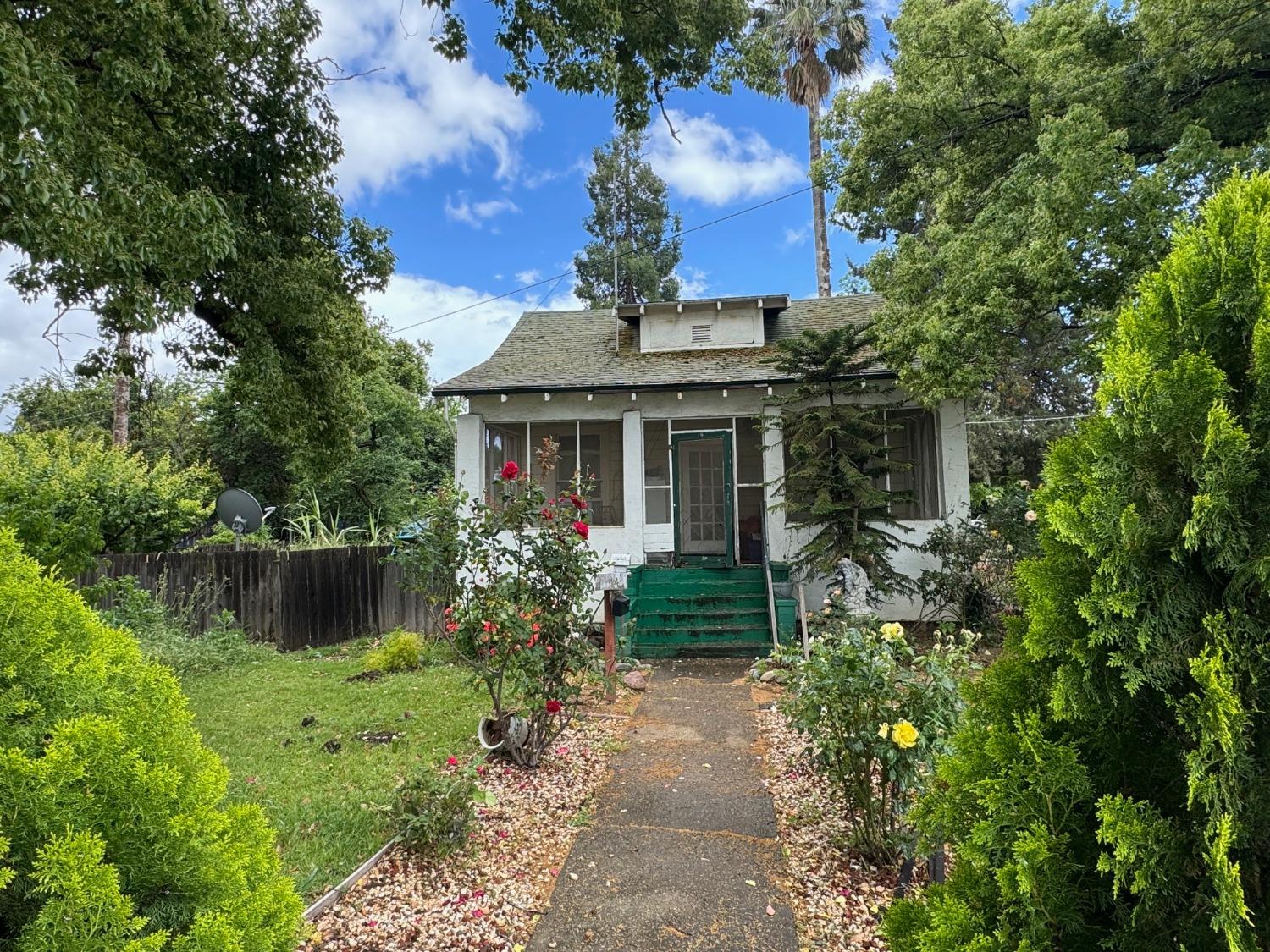 a front view of a house with a garden