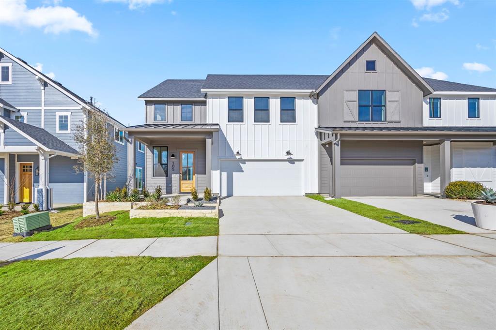 View of front of house featuring a garage and a front lawn