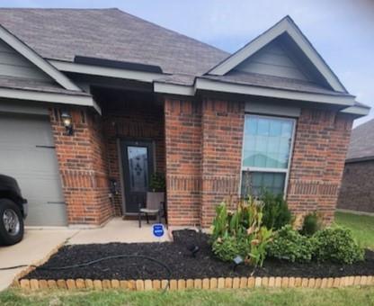 a view of a house with a small yard and plants