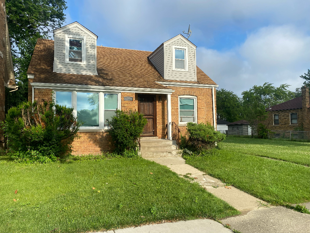 a front view of a house with a yard and porch