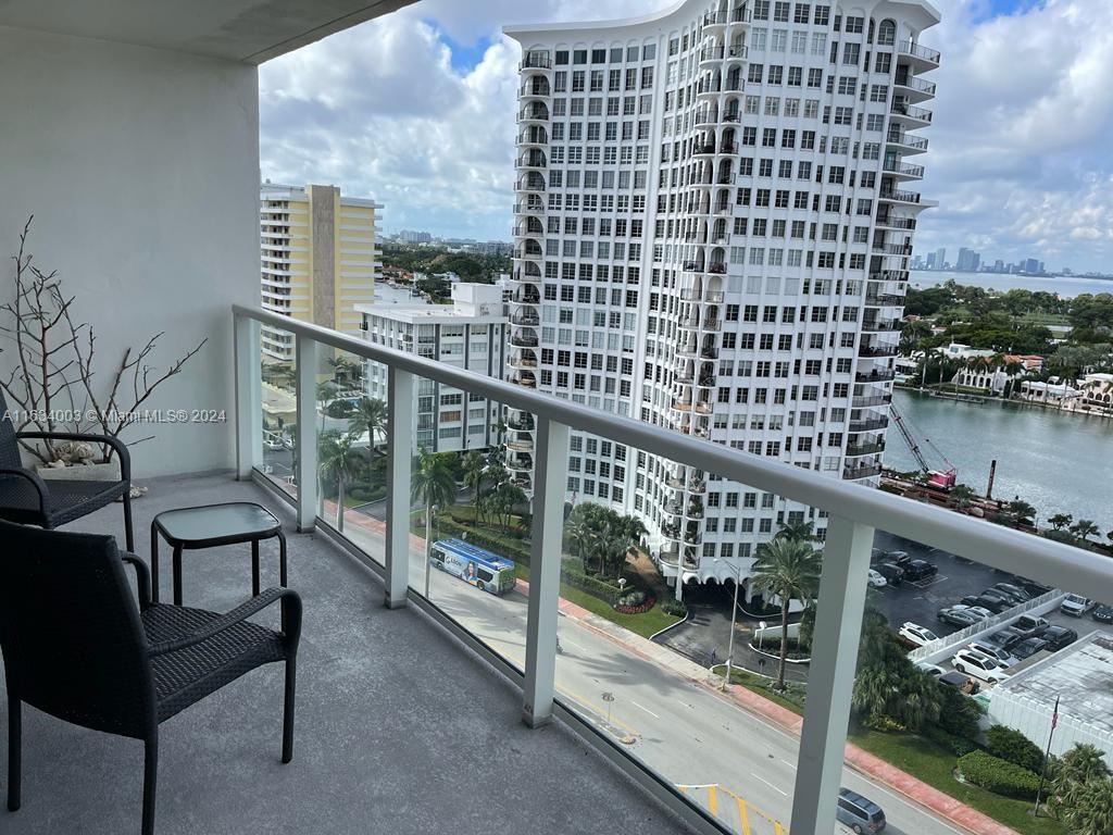 a city view from a balcony with outdoor seating