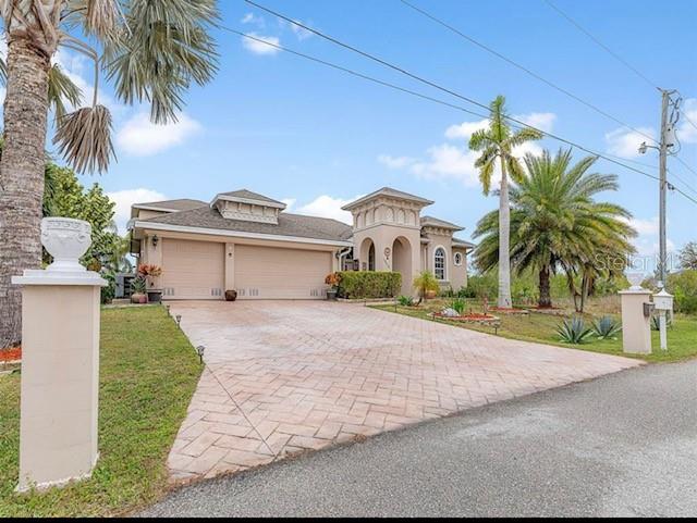 a front view of house with small garden and palm trees