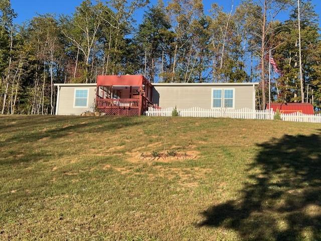 a view of a house with a yard and garage