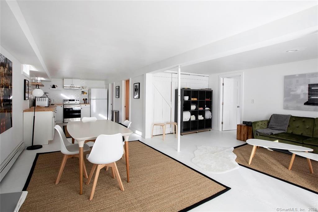 a dining room with furniture and wooden floor