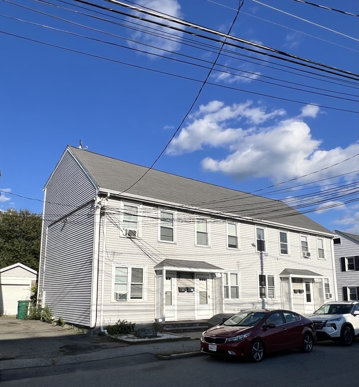 a front view of a residential apartment building with a yard