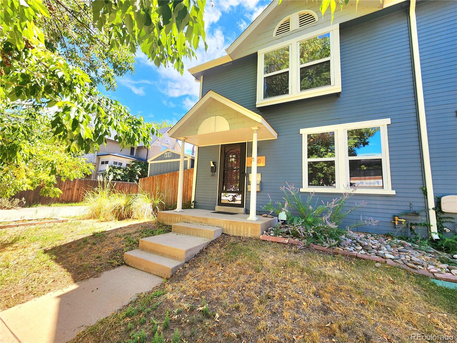 a front view of a house with a yard and seating space