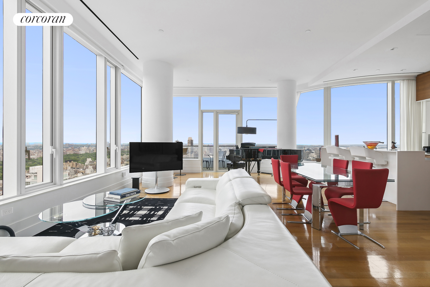 a living room with furniture and large windows