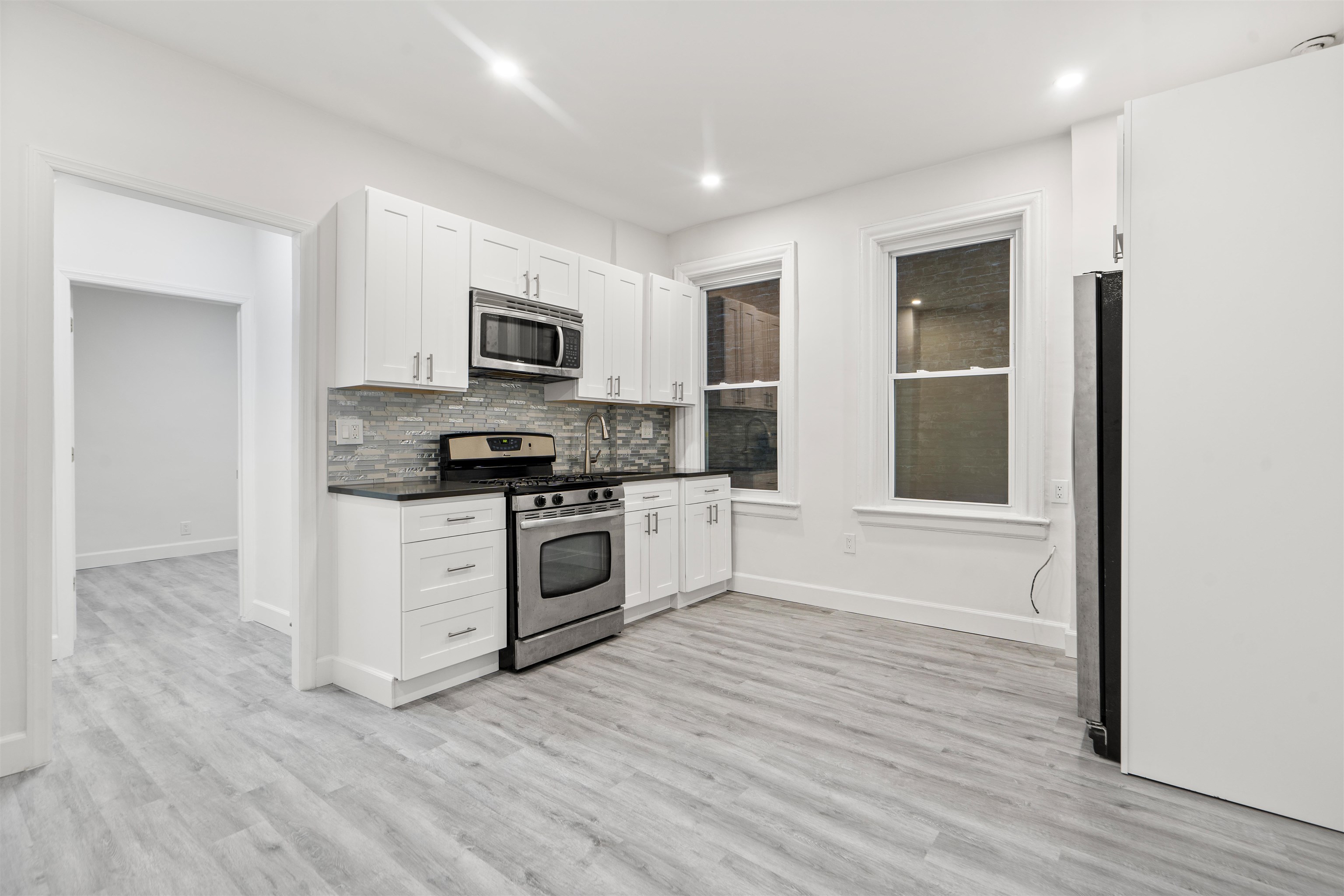 a kitchen with granite countertop a refrigerator and a stove