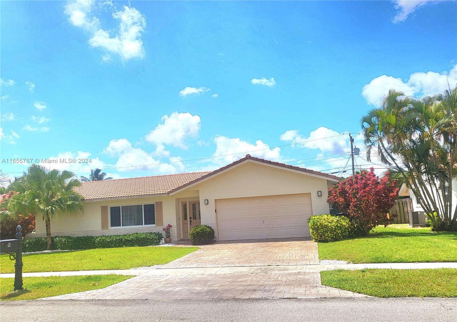 a front view of a house with a yard and a garage