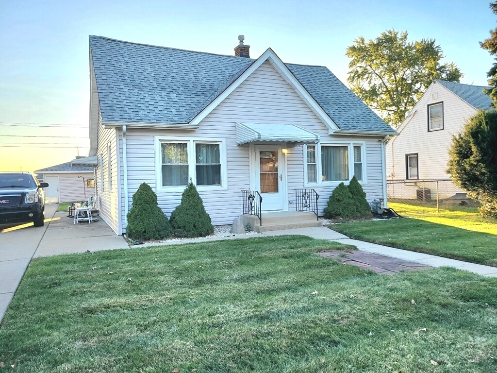 a front view of a house with a yard and porch