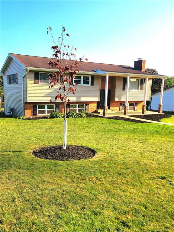 a view of a house with swimming pool and a yard