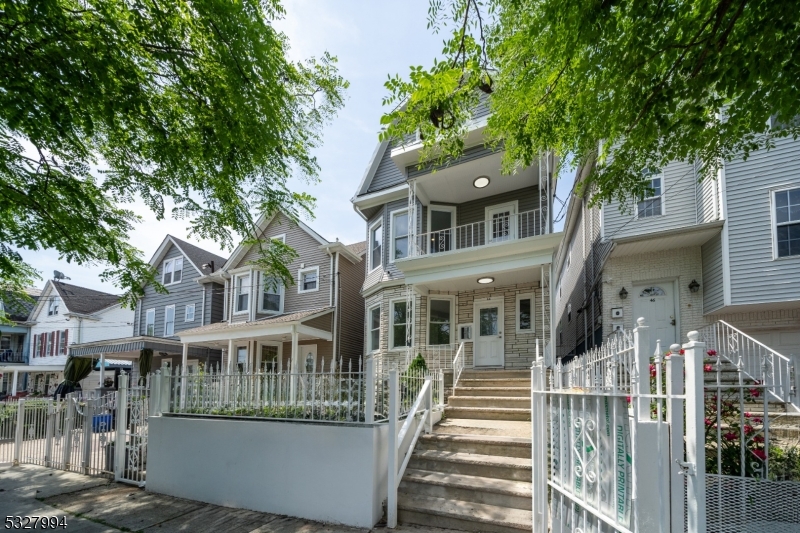 front view of a house with a tree